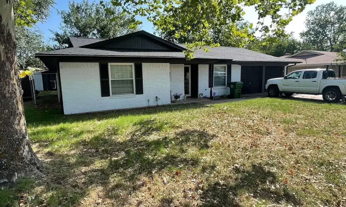 Professional roofing crew working on a residential roof in Timnath